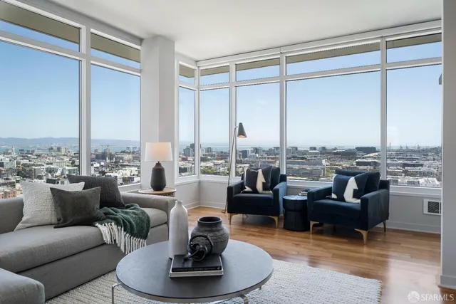 a living room with furniture large windows and a view of lake