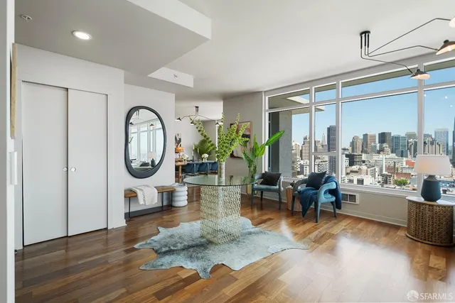 a living room with furniture window and wooden floor