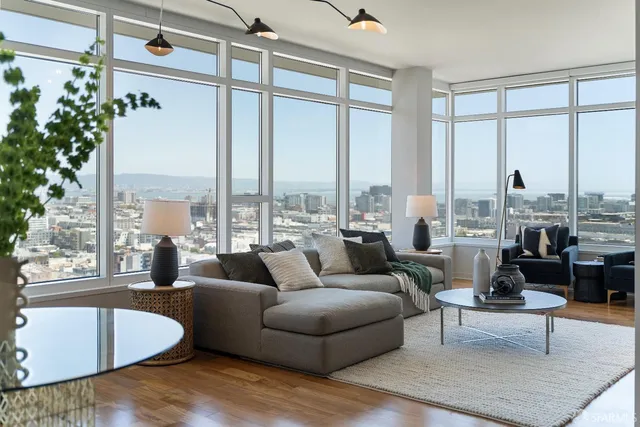 a living room with furniture and large windows