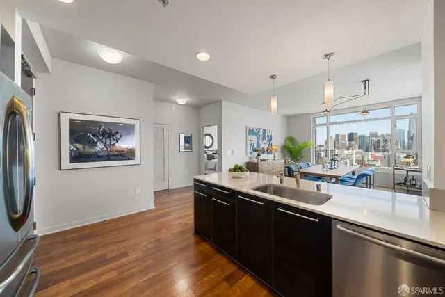 a kitchen with stainless steel appliances granite countertop a sink stove and wooden floor
