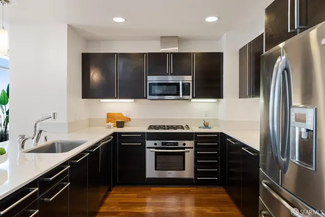 a kitchen with a sink and steel appliances