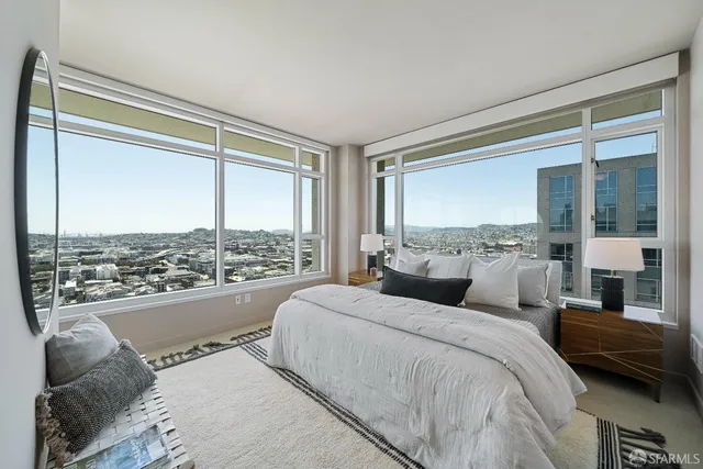 a bedroom with a large bed and a large window