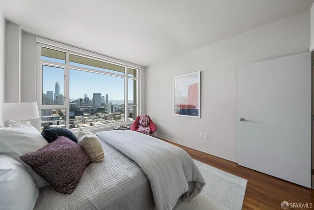 a bed room with bed and a large window