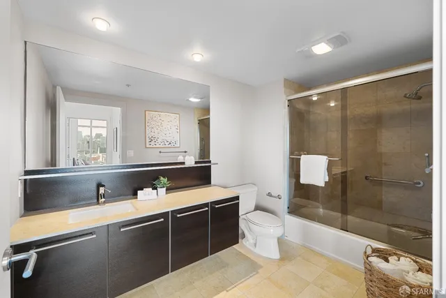 a bathroom with a sink mirror toilet and bathtub