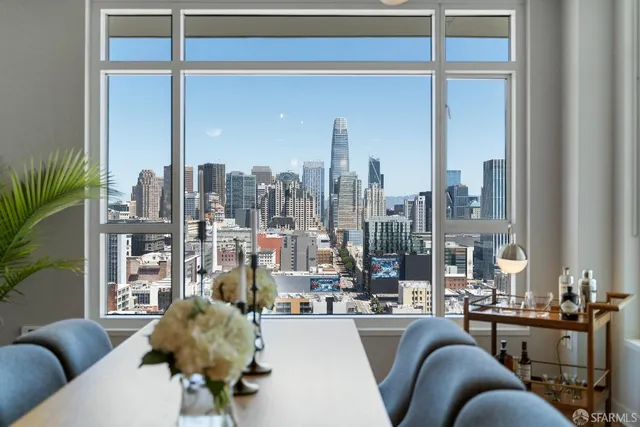 a living room with furniture and large windows