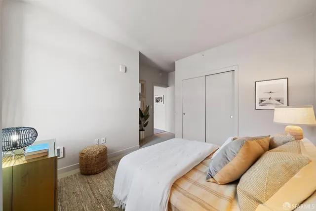 a bedroom with a bed and a couch