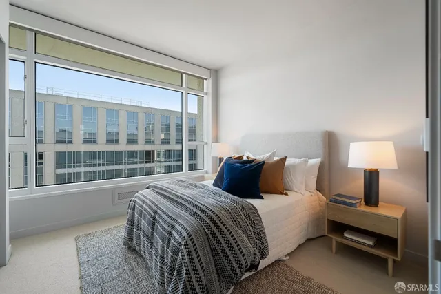a bed sitting in a bedroom next to a window
