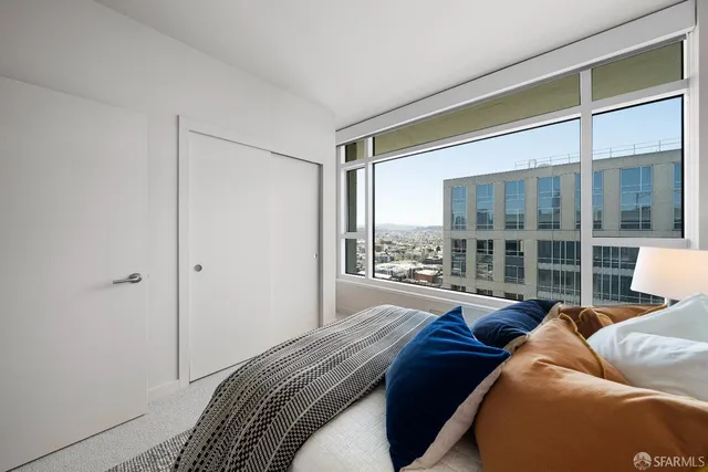 a bedroom with a bed and glass window