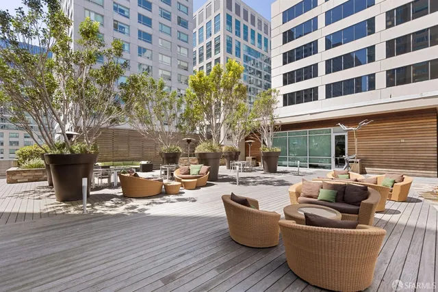 a view of a patio with couches chairs and a fire pit