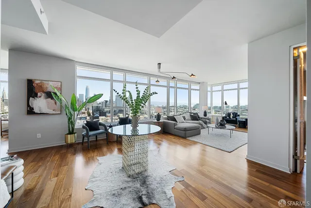 a living room with fireplace furniture and wooden floor