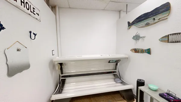 a bench sitting in a room next to a window