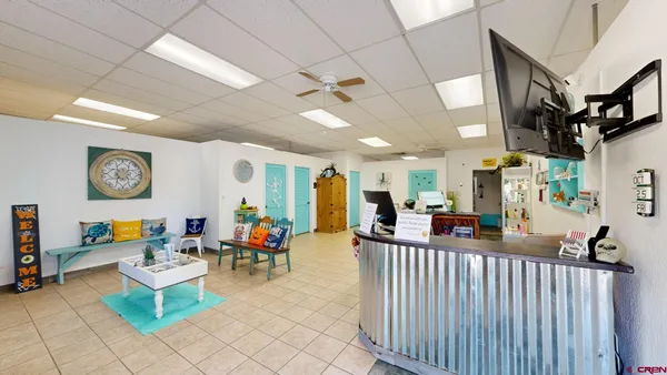 a living room with fireplace furniture and a large window