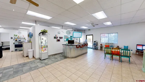 a living room with furniture and kitchen view
