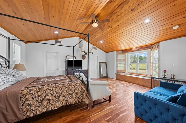 a bedroom with a bed window and couch