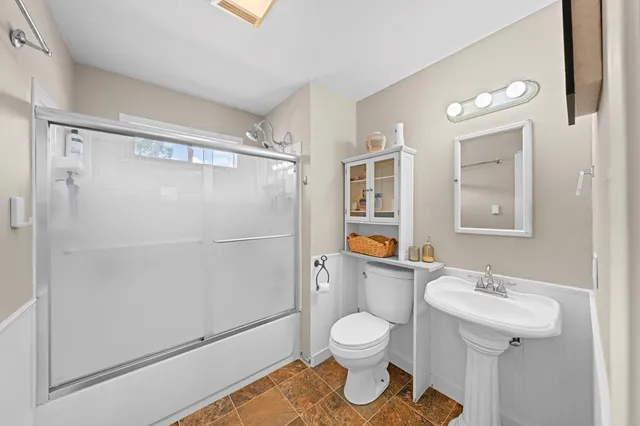 a bathroom with a sink toilet and shower