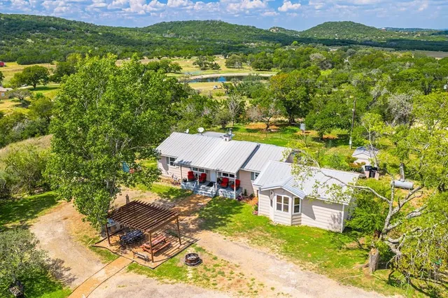 an aerial view of residential houses with outdoor space and swimming pool