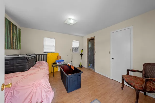 a bed room with furniture and a chair