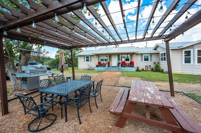 a view of a backyard with furniture porch and wooden floor