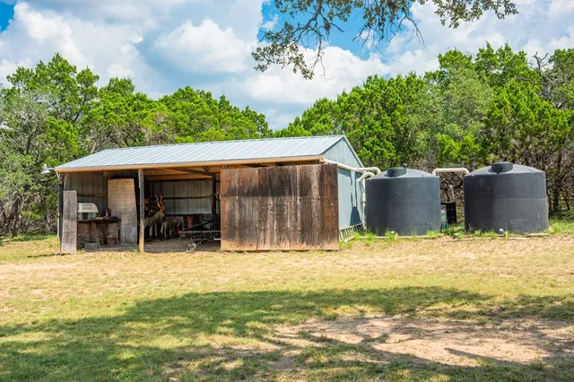 a backyard of a house with table and chairs