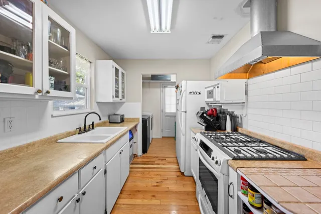 a large kitchen with a stove and a sink