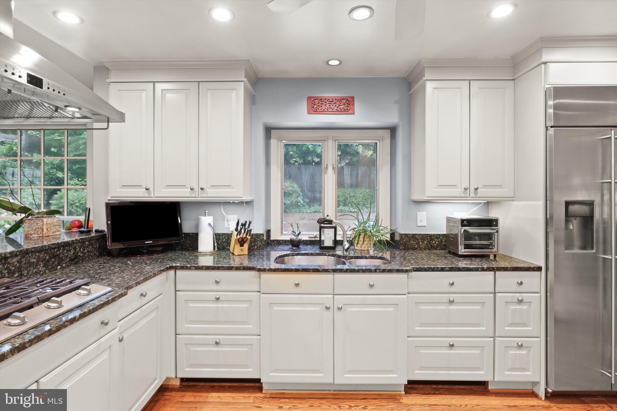 2905 Dartmouth Road Alexandria, VA 22314 - Photo 9 of 28 a kitchen with granite countertop a sink window and cabinets