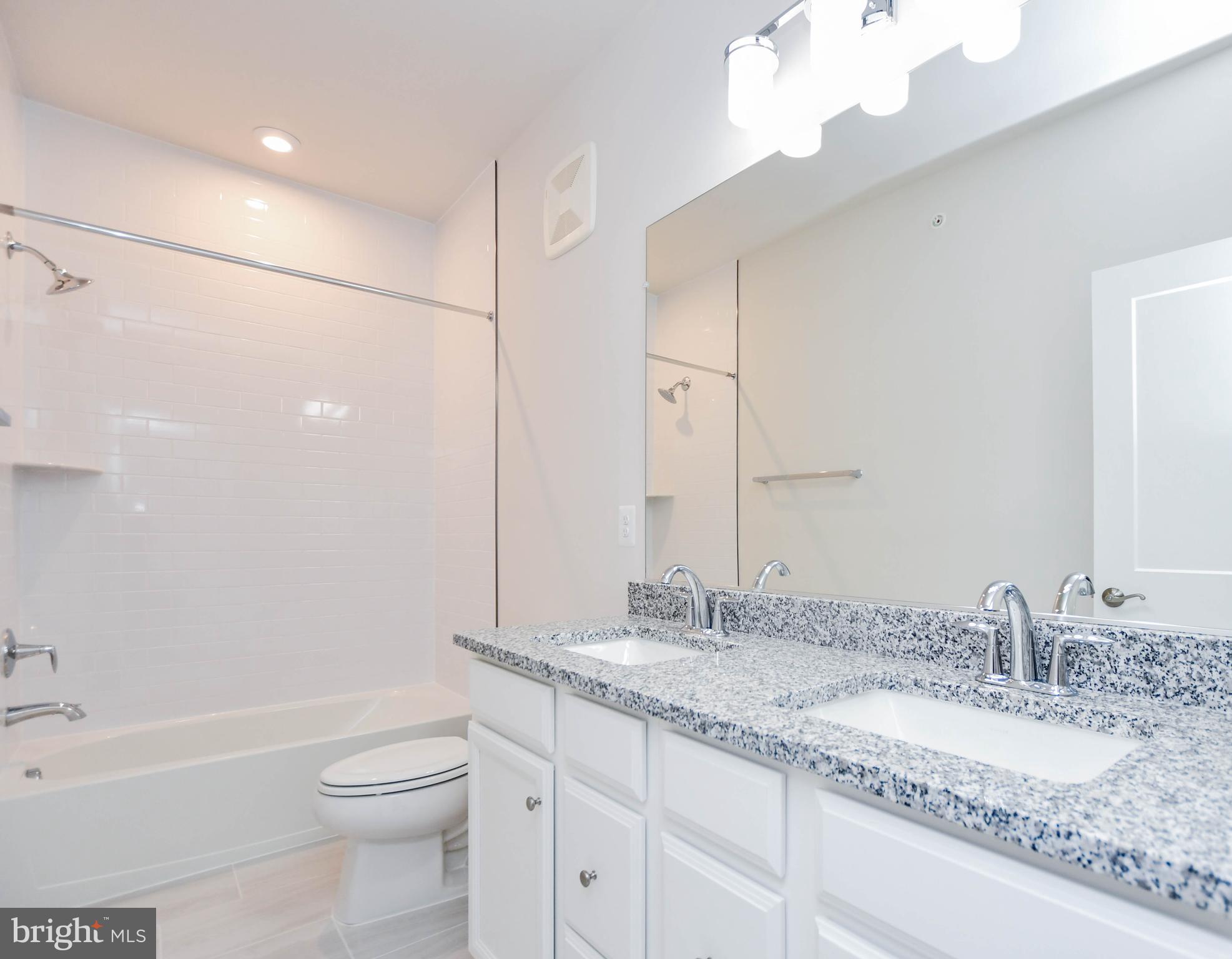 44502 Wolfhound Square Ashburn, VA 20147 - Photo 32 of 100 a bathroom with a granite countertop sink a toilet and bathtub