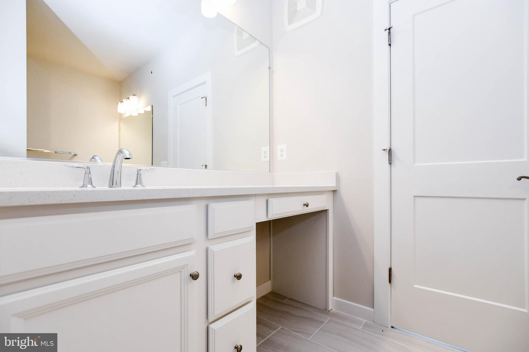 44502 Wolfhound Square Ashburn, VA 20147 - Photo 34 of 100 a bathroom with a sink and a mirror