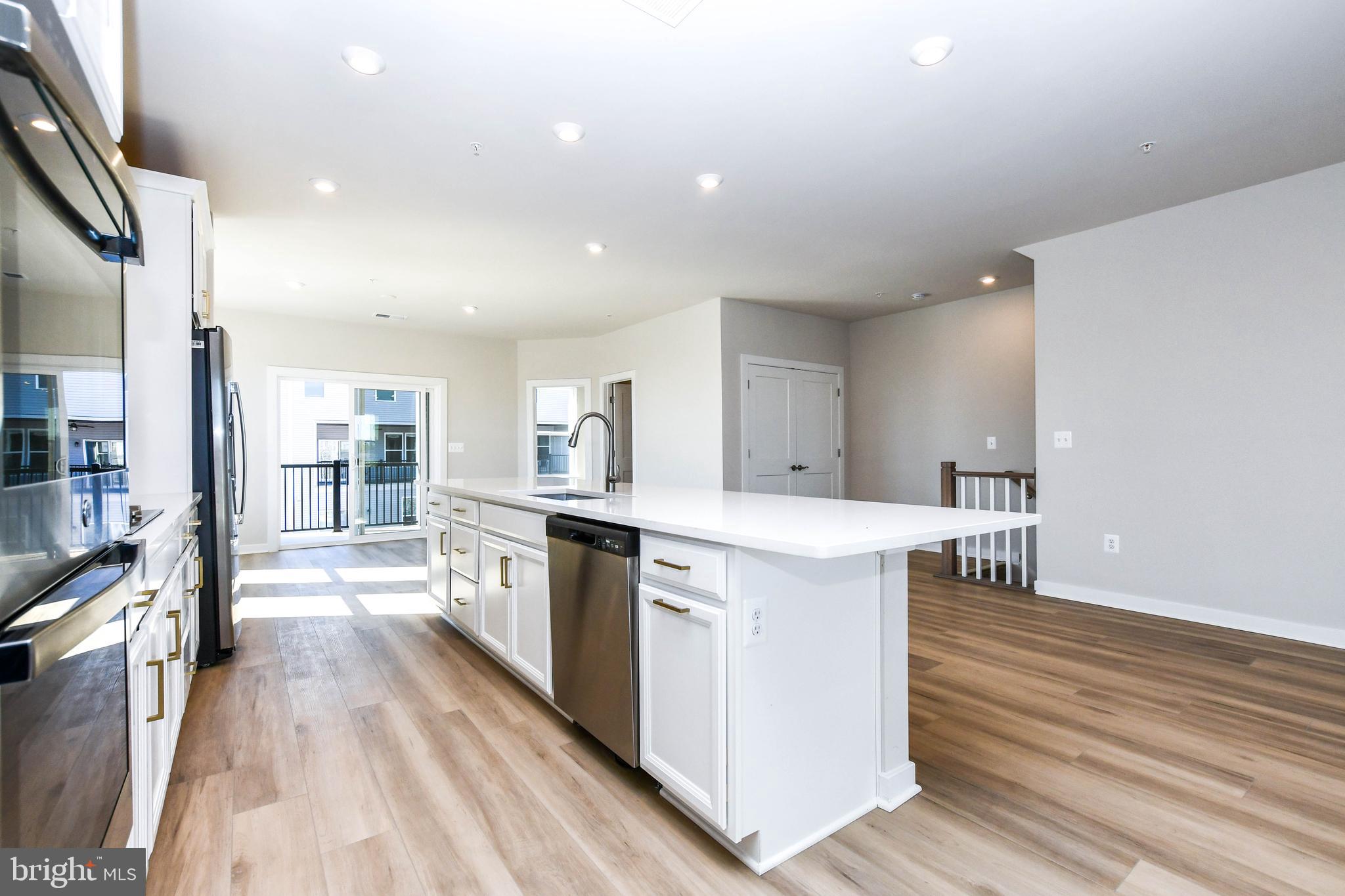 44502 Wolfhound Square Ashburn, VA 20147 - Photo 49 of 100 a large kitchen with stainless steel appliances a large counter top a stove and a refrigerator
