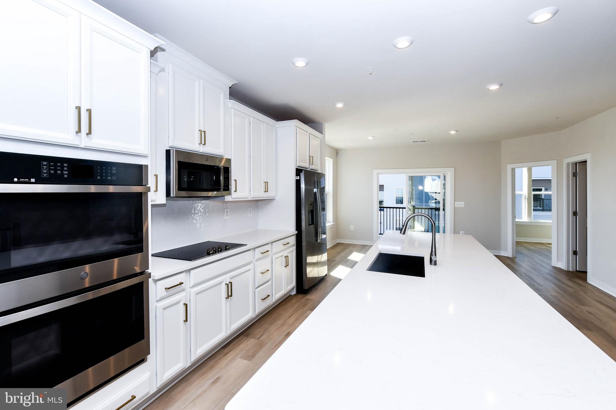 44502 Wolfhound Square Ashburn, VA 20147 - Photo 51 of 100 a large white kitchen with stainless steel appliances