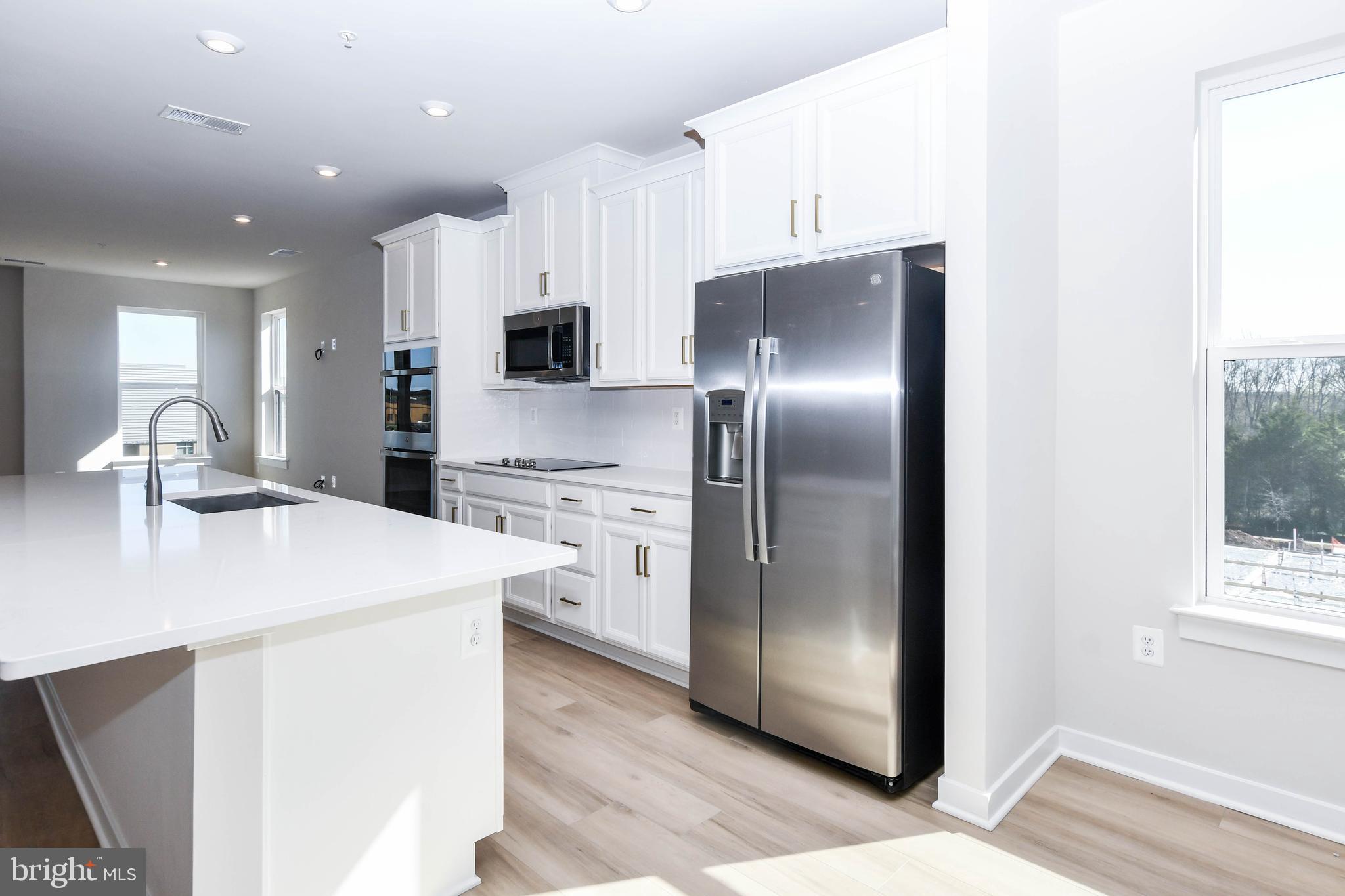 44502 Wolfhound Square Ashburn, VA 20147 - Photo 52 of 100 a kitchen with stainless steel appliances a refrigerator sink and microwave