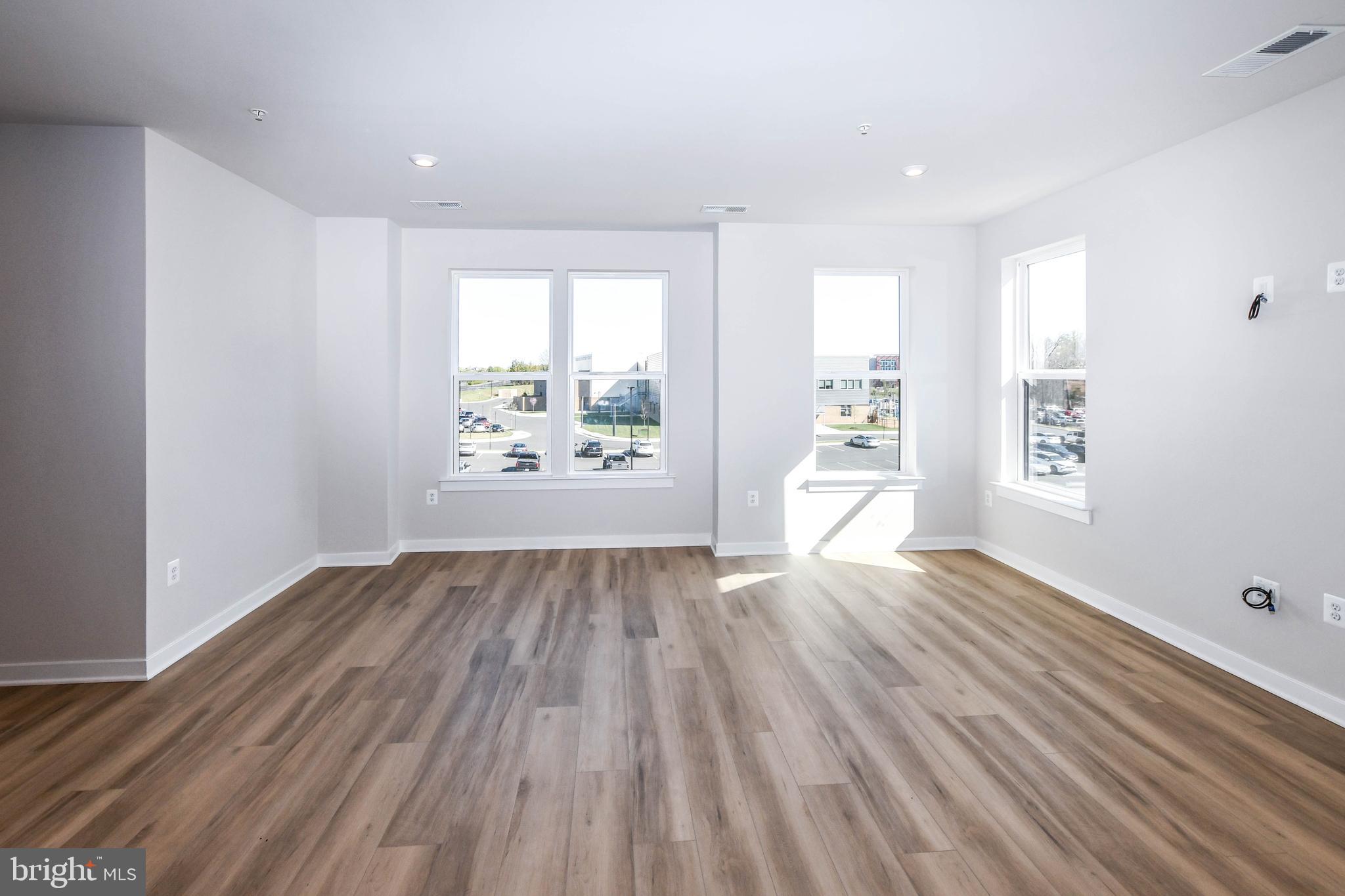 44502 Wolfhound Square Ashburn, VA 20147 - Photo 55 of 100 an empty room with wooden floor and windows