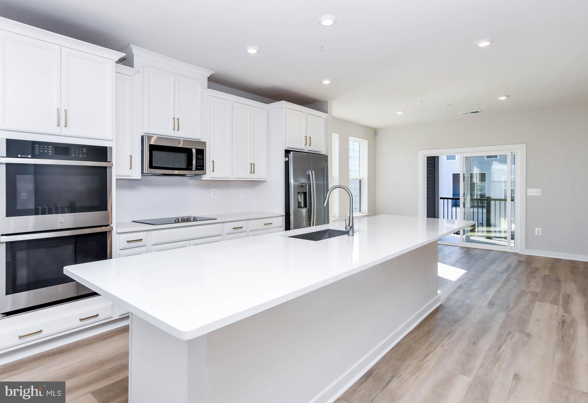44502 Wolfhound Square Ashburn, VA 20147 - Photo 56 of 100 a large kitchen with a large counter top appliances and cabinets
