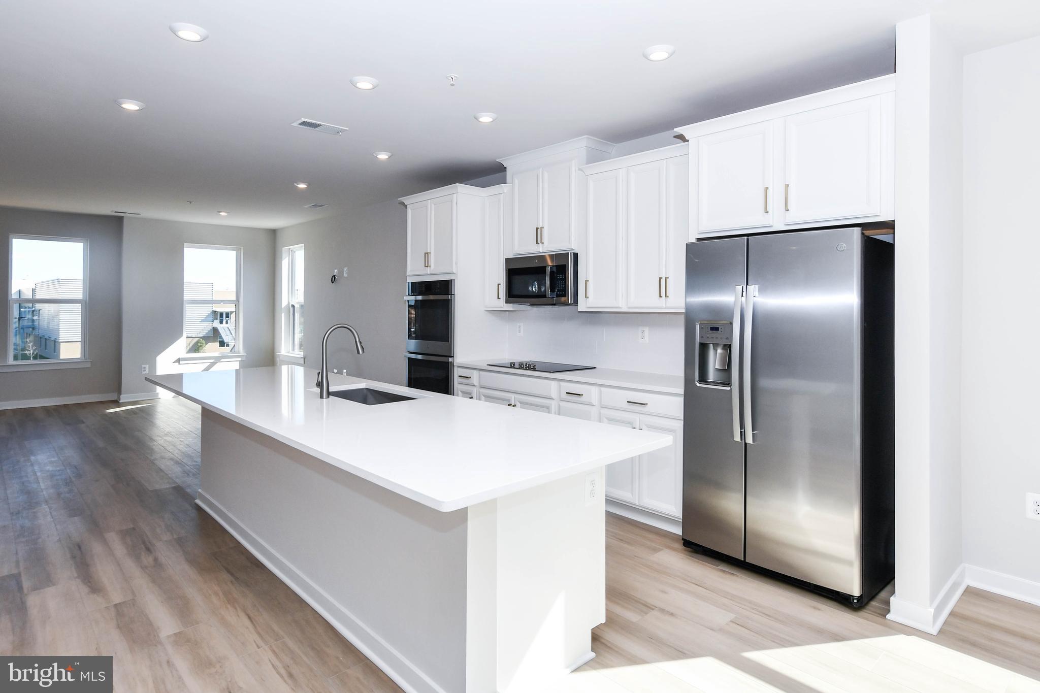 44502 Wolfhound Square Ashburn, VA 20147 - Photo 57 of 100 a large kitchen with stainless steel appliances a refrigerator and a stove top oven