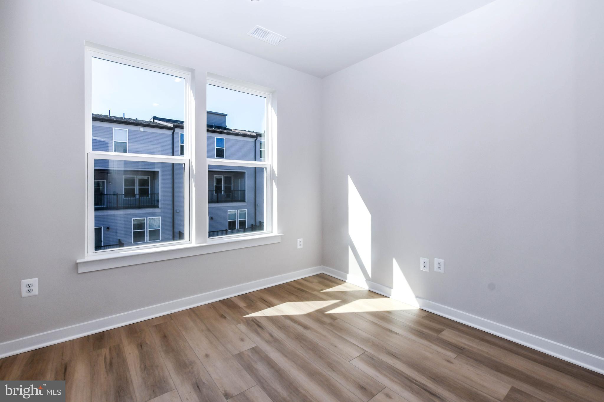 44502 Wolfhound Square Ashburn, VA 20147 - Photo 64 of 100 an empty room with wooden floor and windows