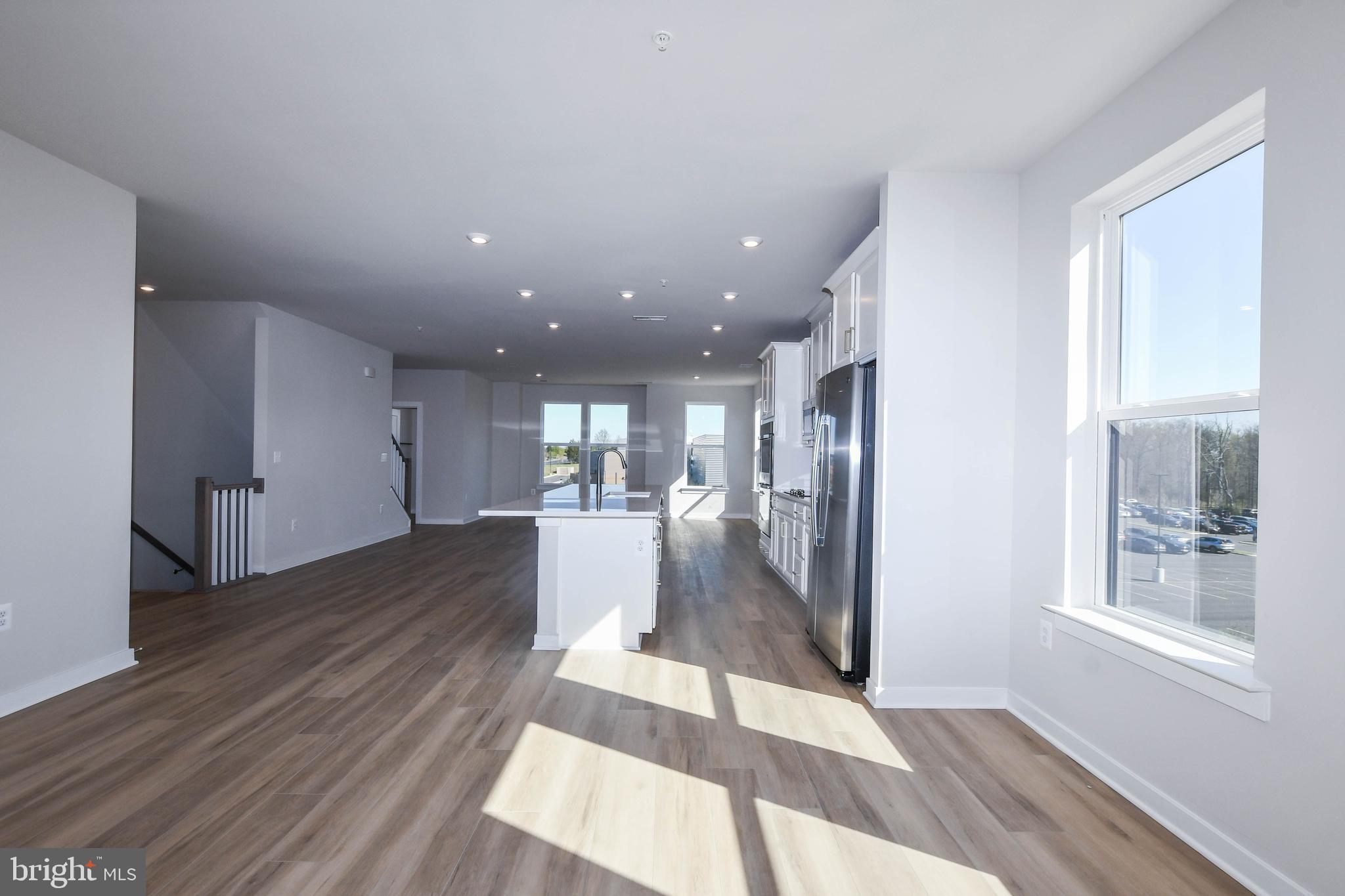 44502 Wolfhound Square Ashburn, VA 20147 - Photo 65 of 100 a view of a living room with wooden floor and a kitchen