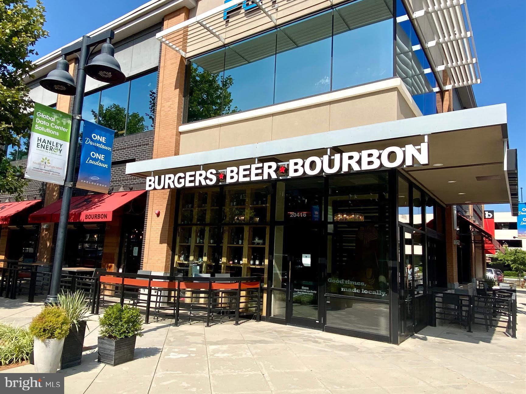 44502 Wolfhound Square Ashburn, VA 20147 - Photo 72 of 100 a view of a cafe with a couple of people seating on table and chairs