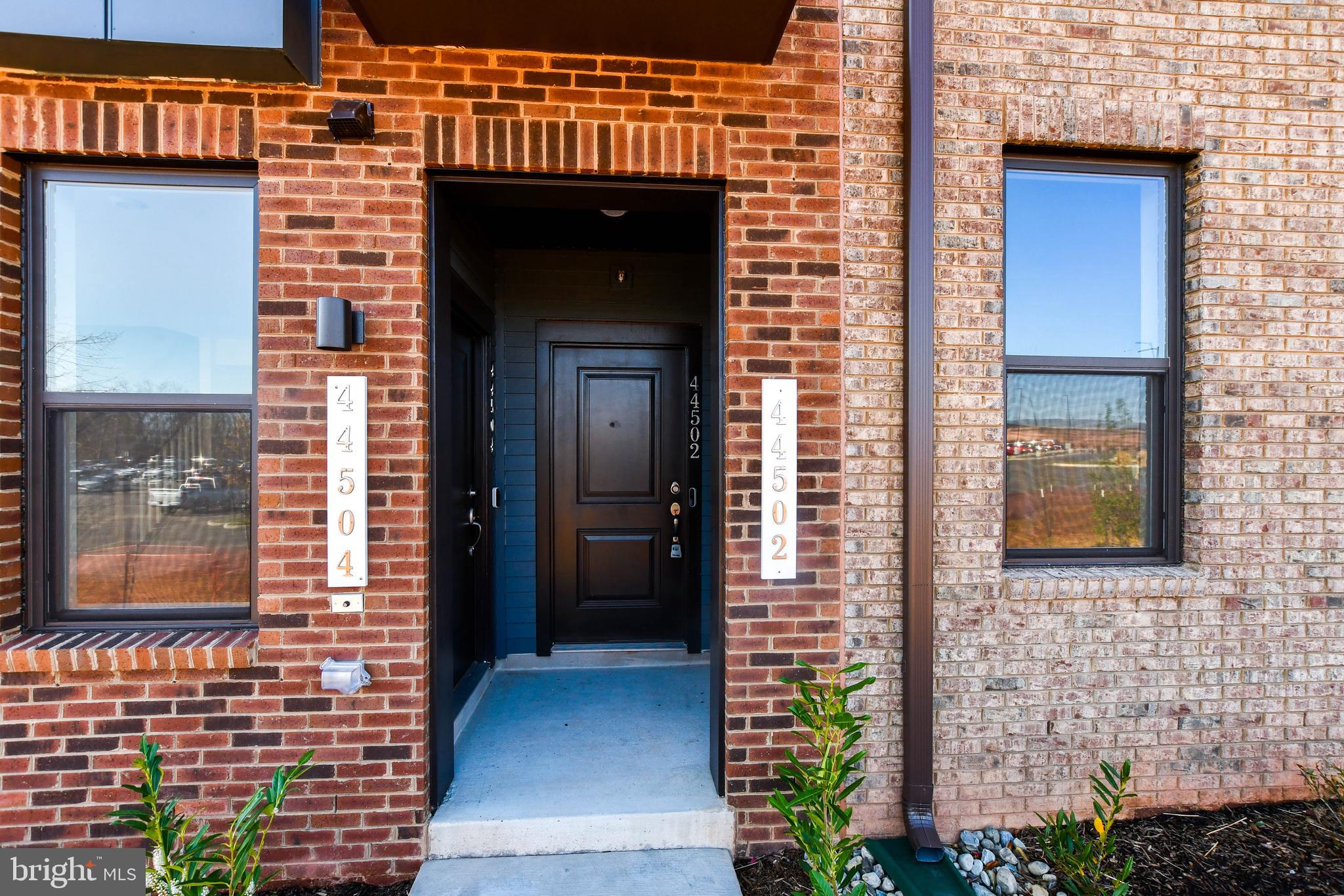 44502 Wolfhound Square Ashburn, VA 20147 - Photo 98 of 100 a front view of a house with a garden
