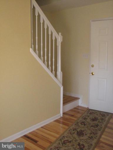 11522 Wrangler Road Lusby, MD 20657 - Photo 17 of 17 ENTRANCE INTO MAINLEVEL AND STAIRWAY ALL HARDWOOD