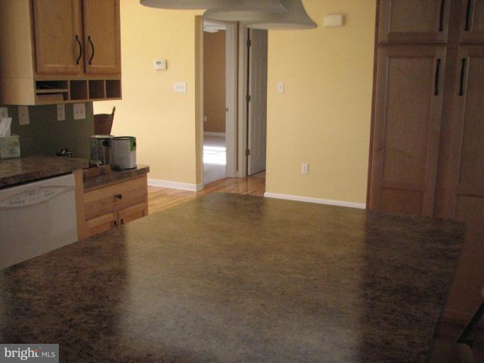 11522 Wrangler Road Lusby, MD 20657 - Photo 6 of 17 Kitchen island plus the hallway