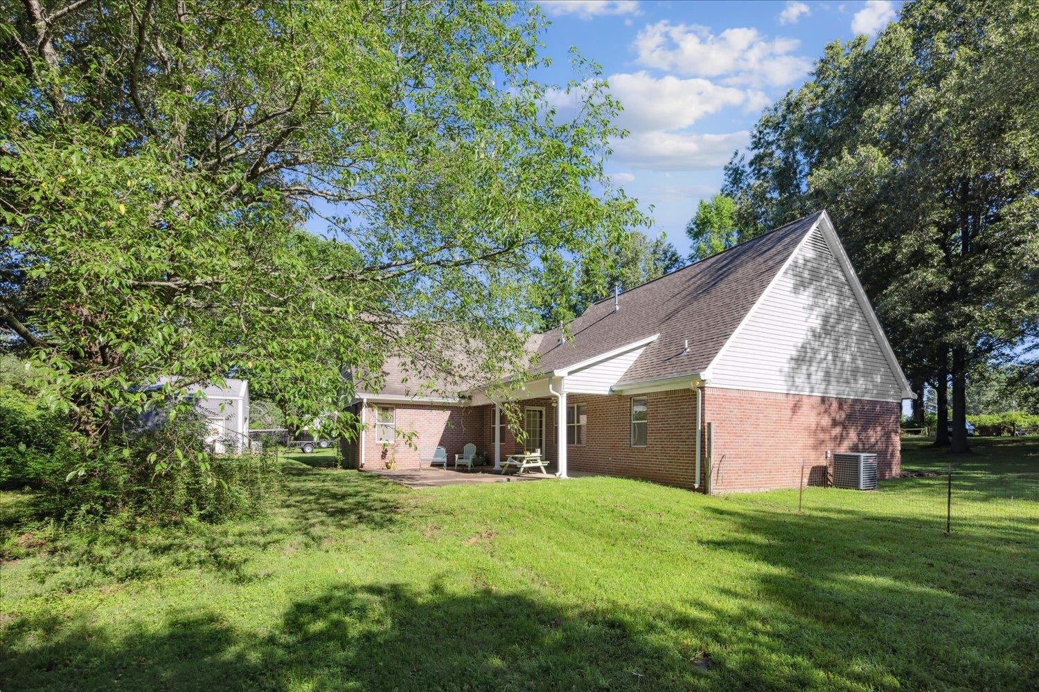 6473 Pleasant Ridge Road Millington, TN 38053 - Photo 20 of 23 View of yard featuring cooling unit and a patio