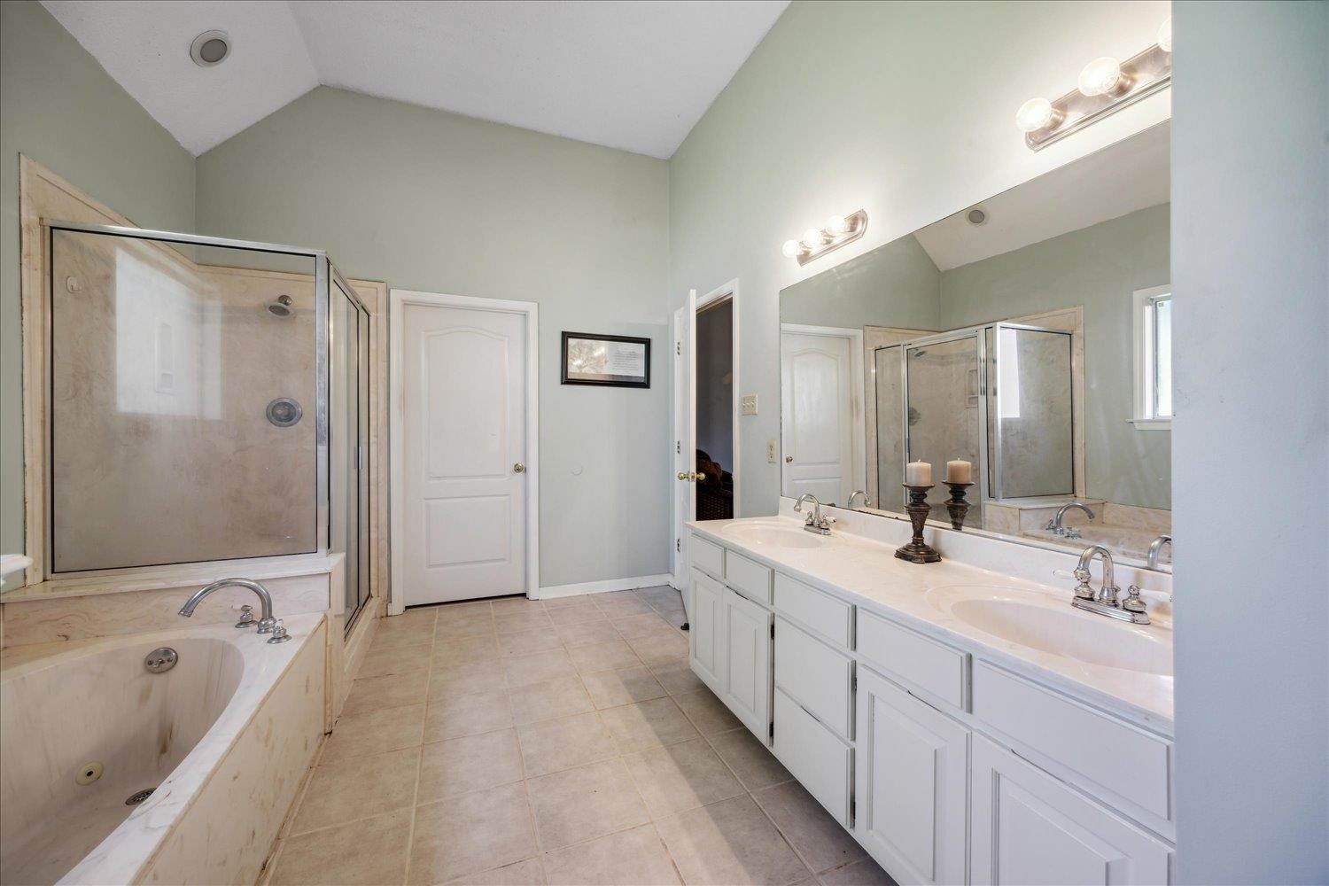 6473 Pleasant Ridge Road Millington, TN 38053 - Photo 10 of 23 Bathroom featuring tile patterned floors, double vanity, shower with separate bathtub, and vaulted ceiling
