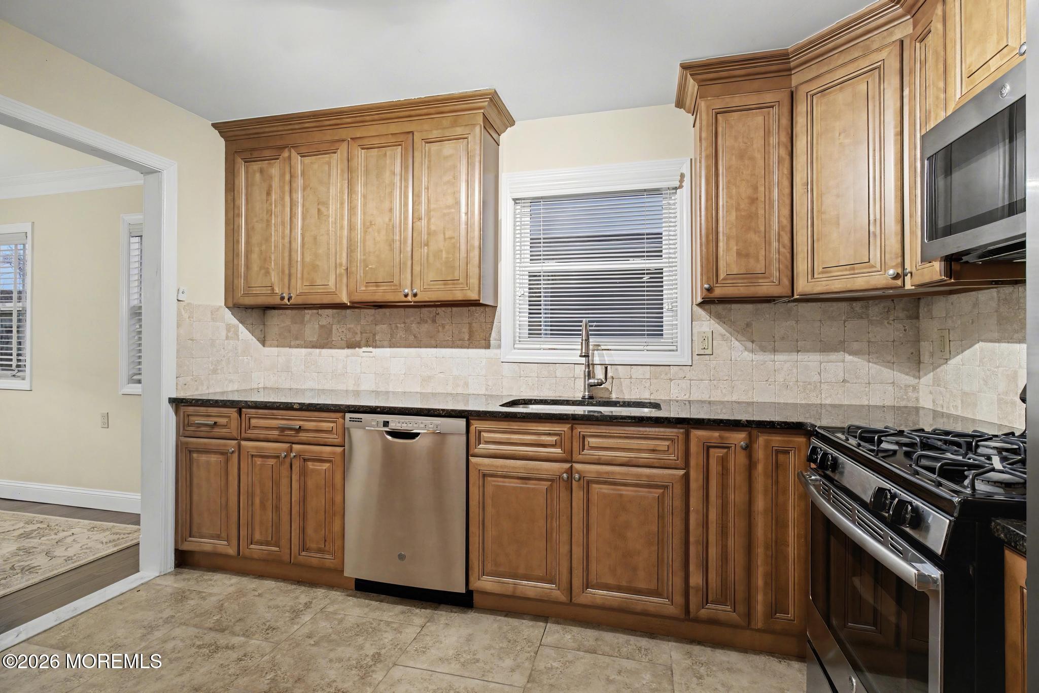 203 Blake Circle Brick, NJ 08724 - Photo 16 of 40 a kitchen with granite countertop cabinets stainless steel appliances and a sink
