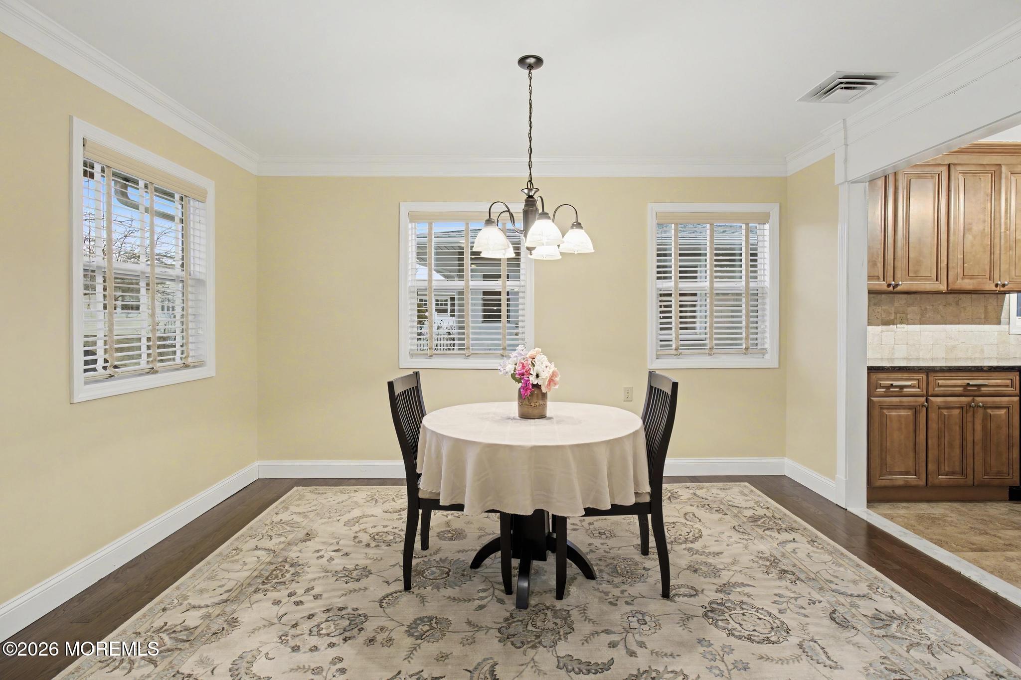 203 Blake Circle Brick, NJ 08724 - Photo 18 of 40 a dining room with furniture a chandelier and wooden floor