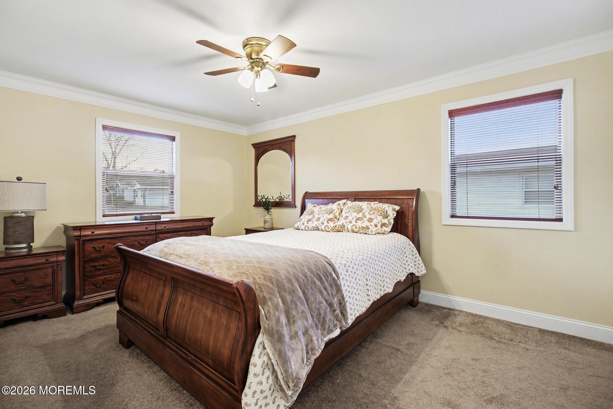 203 Blake Circle Brick, NJ 08724 - Photo 21 of 40 a bedroom with a bed and a chandelier
