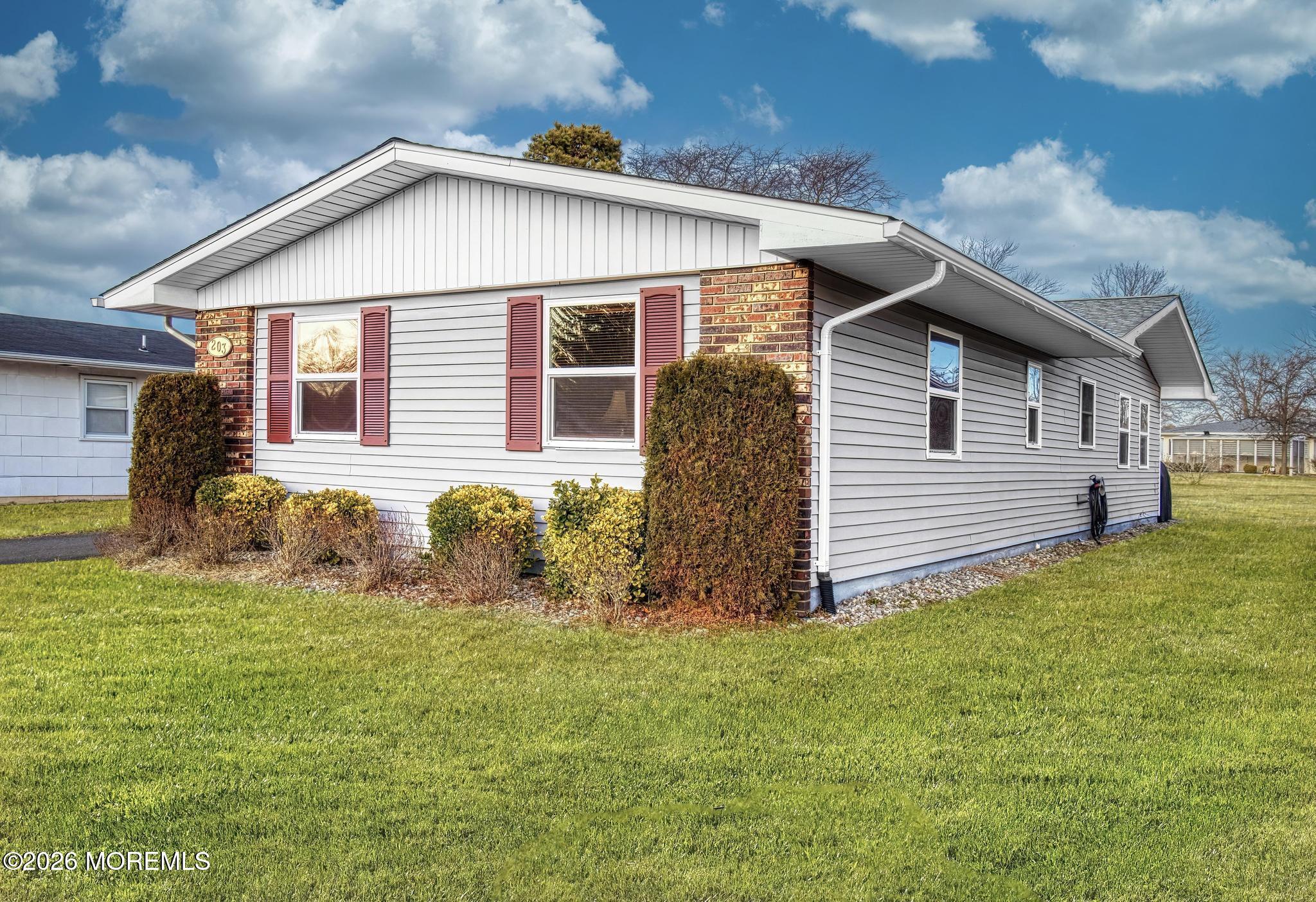 203 Blake Circle Brick, NJ 08724 - Photo 3 of 40 a front view of house with yard and trees in the background