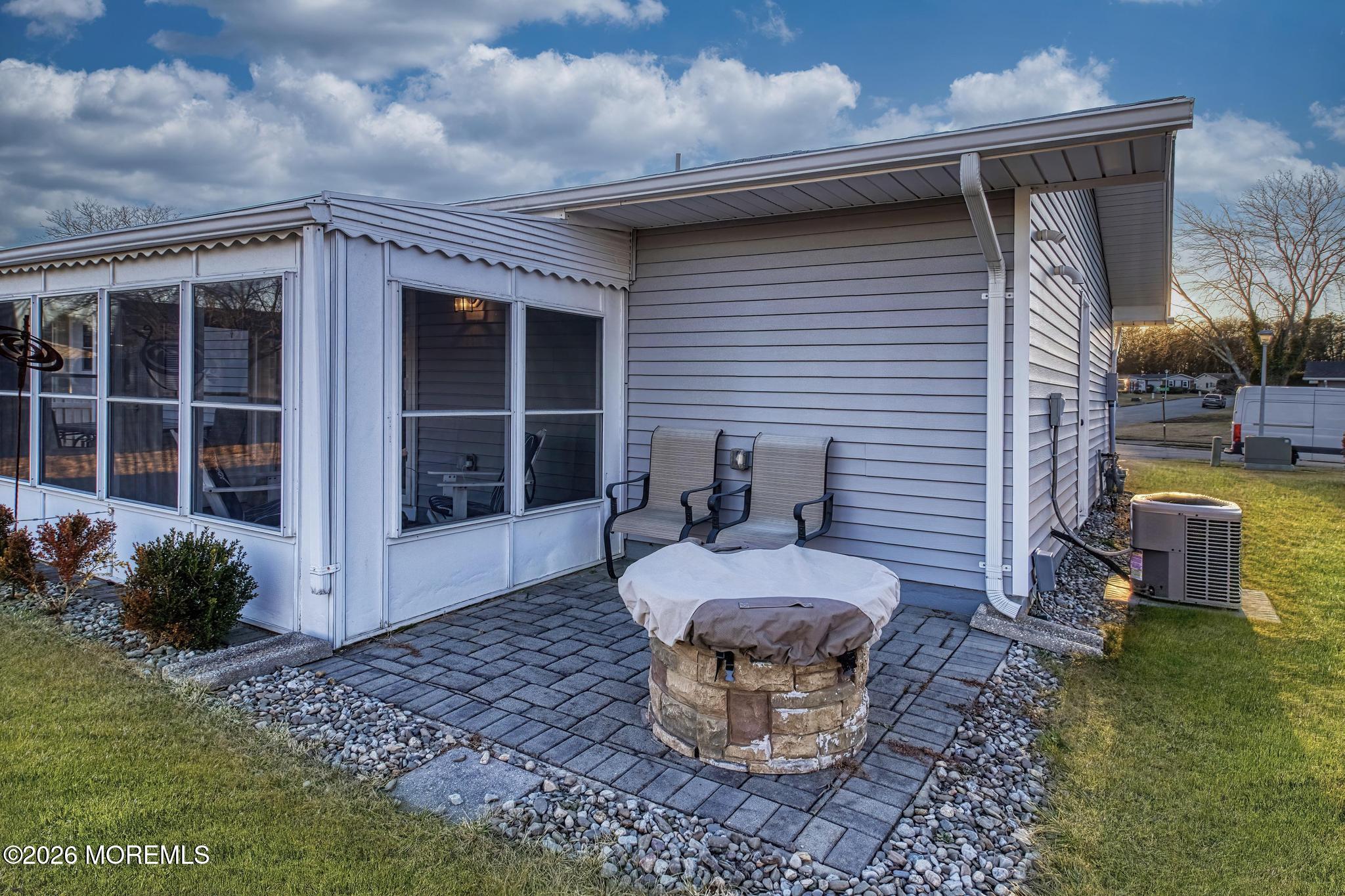203 Blake Circle Brick, NJ 08724 - Photo 6 of 40 a view of a patio with table and chairs and potted plants