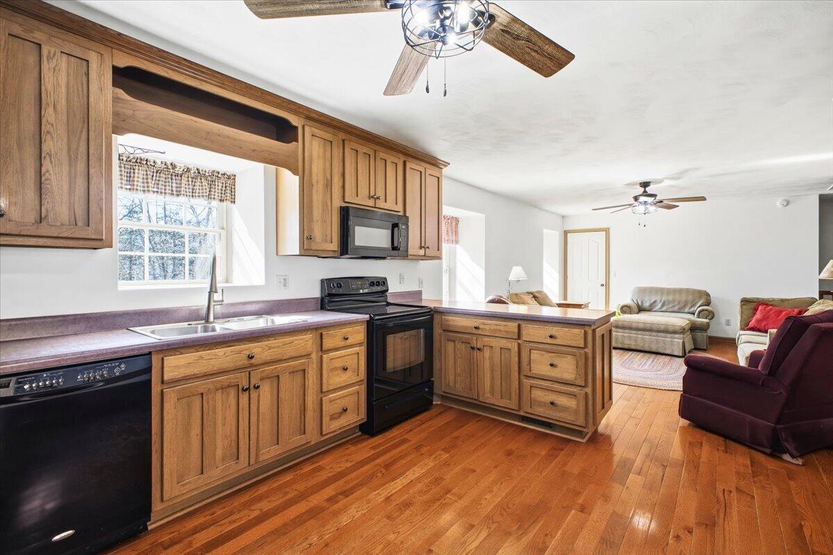 3282 Absalom Smith Road Salem, VA 24153 - Photo 12 of 59 a kitchen with stainless steel appliances granite countertop a stove a sink dishwasher and a microwave oven with cabinets