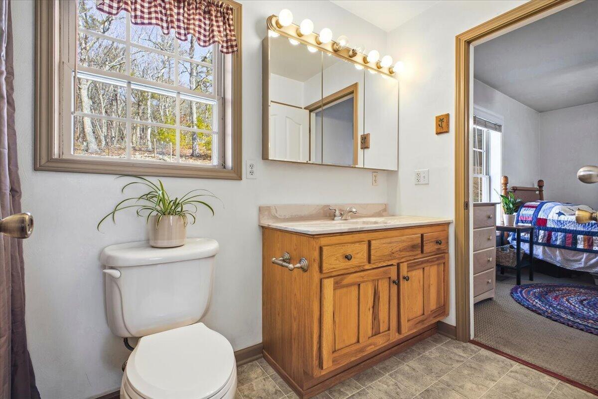 3282 Absalom Smith Road Salem, VA 24153 - Photo 16 of 59 a bathroom with a granite countertop toilet sink and mirror