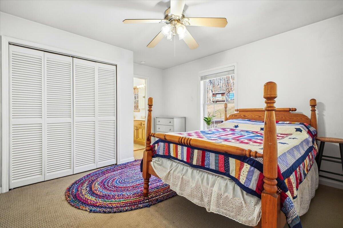 3282 Absalom Smith Road Salem, VA 24153 - Photo 19 of 59 a bedroom with a bed and a chandelier