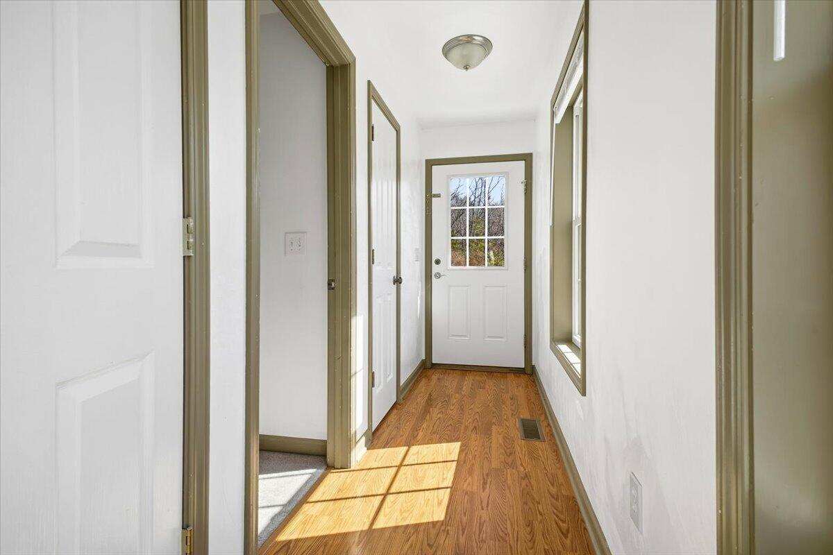 3282 Absalom Smith Road Salem, VA 24153 - Photo 28 of 59 a view of a hallway with wooden floor and a bathroom